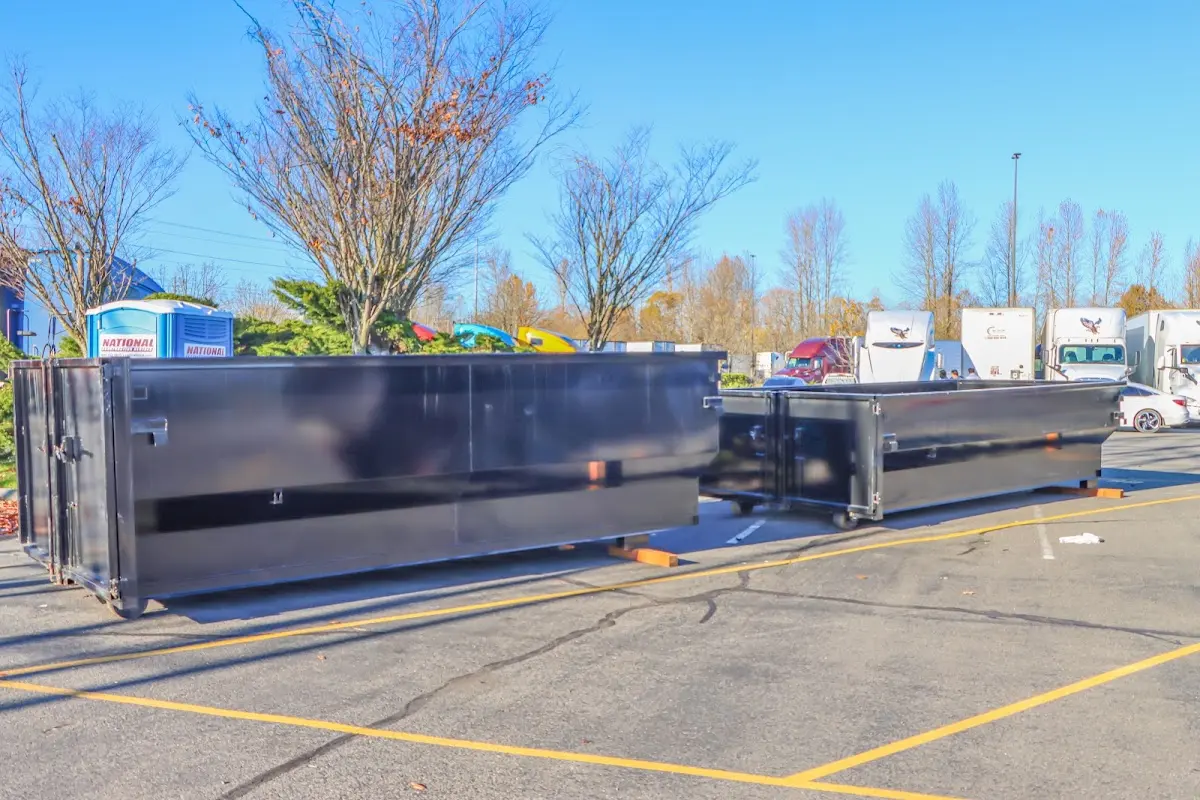 Professional dumpster rental service with roll-off container on residential driveway in Brewster